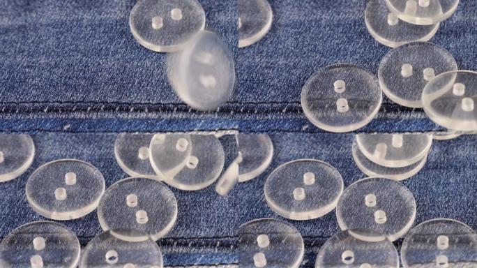 塑料透明纽扣落在牛仔布上。