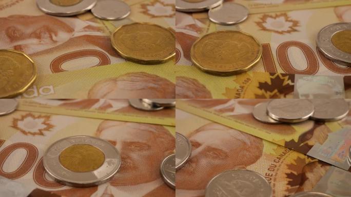 加拿大硬币和100美元聚合物纸币与罗伯特·博登的肖像。