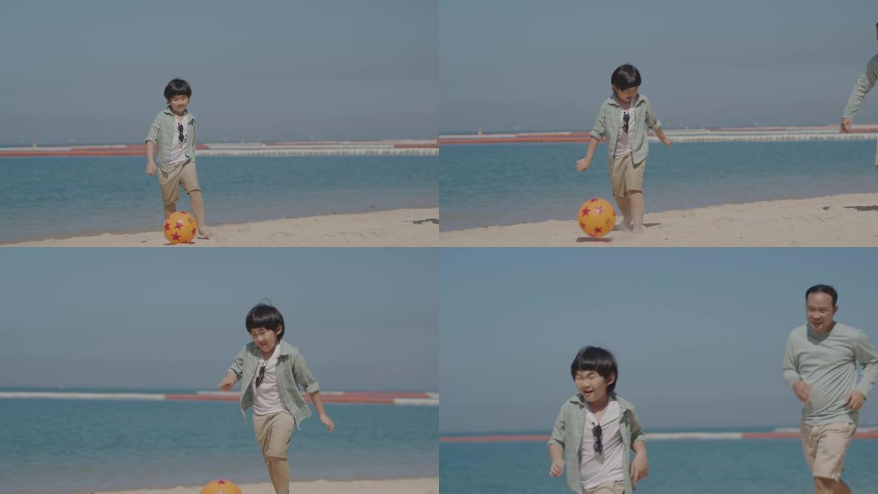 亚洲父亲和儿子在海滩上踢足球。