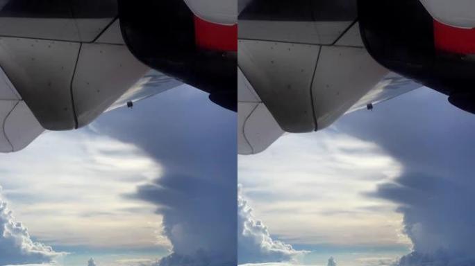 云和阳光穿过的飞机机翼拍摄的垂直视频