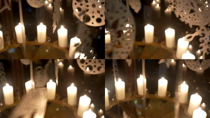降临节白色蜡烛上的旋转装饰由胶合板制成，描绘天使或圣诞树14