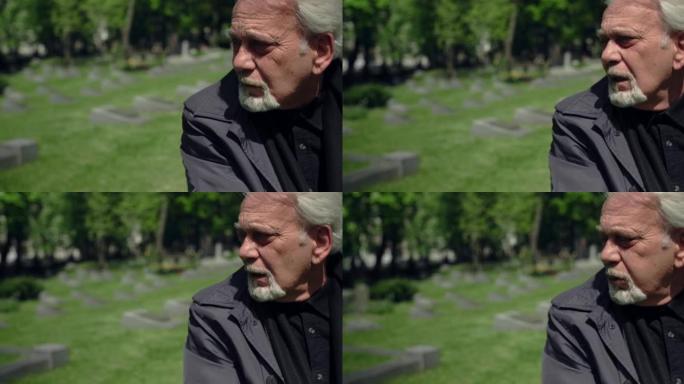 悲伤的白发老人坐在墓地的坟墓上，悲伤和悲伤地失去了亲密的人，4k 60p Prores