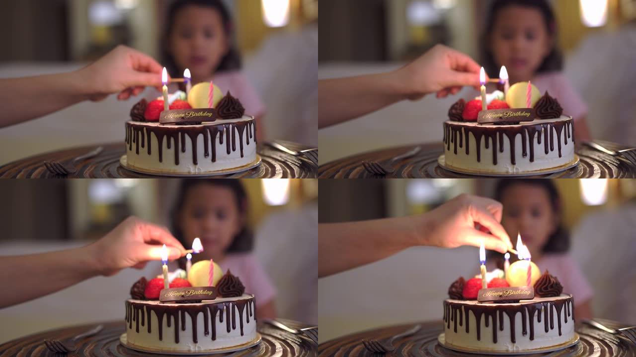 一只手点燃生日蛋糕蜡烛的特写镜头。
