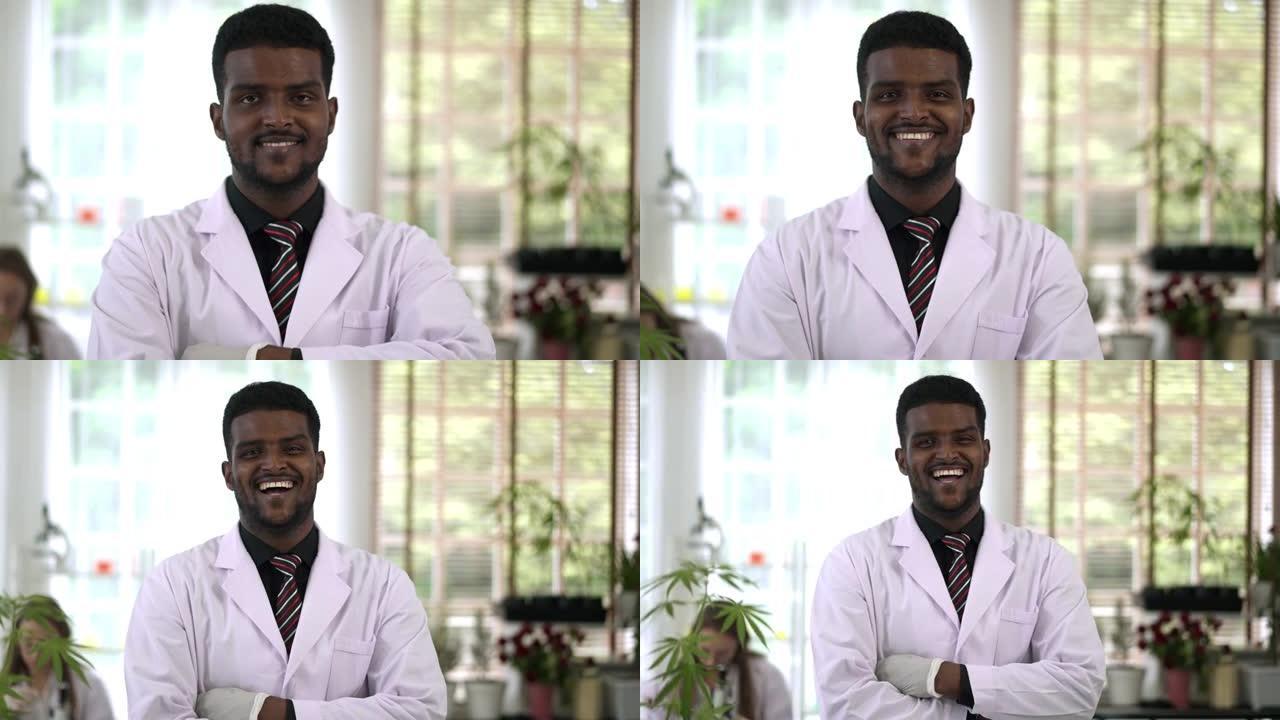 画像年轻的科学家男子交叉双臂站在实验室