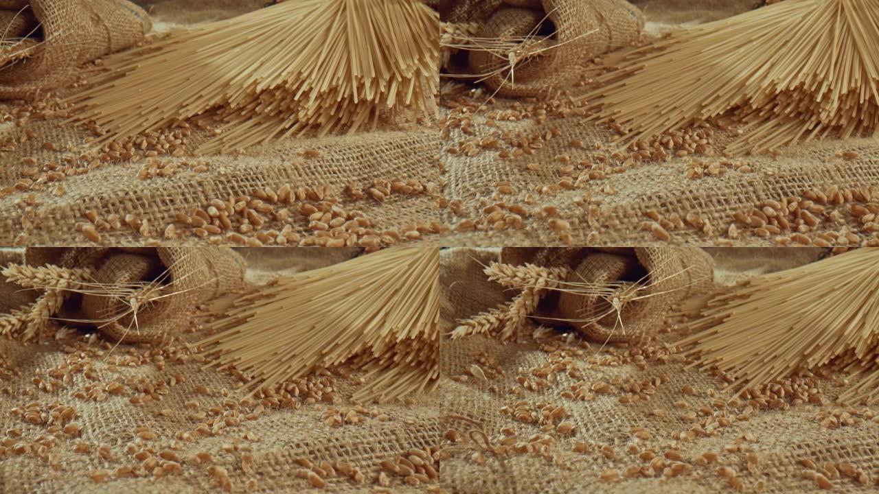 桌布上小麦种子周围的一堆意大利面条