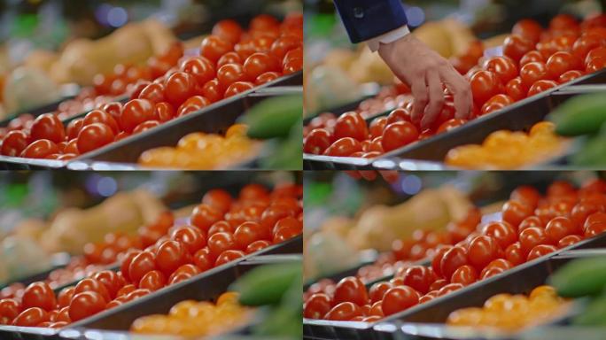 男人在杂货店或市场上拿新鲜成熟的西红柿，用蔬菜，4K，Prores
