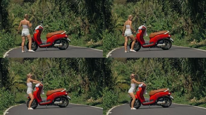 穿短裤的性感女人在丛林路上的摩托车附近跳舞