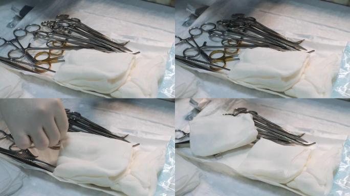 将未包装的无菌手术器械放在手术室的桌子上。手术器械从保护性无菌包装中取出，为手术做好准备