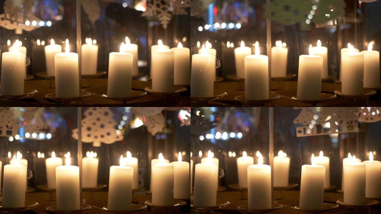 降临节白色蜡烛上的旋转装饰由胶合板制成，描绘天使或圣诞树10p1