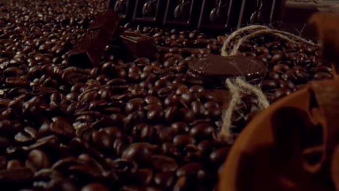 黑巧克力条和肉桂棒放在一堆咖啡豆中间