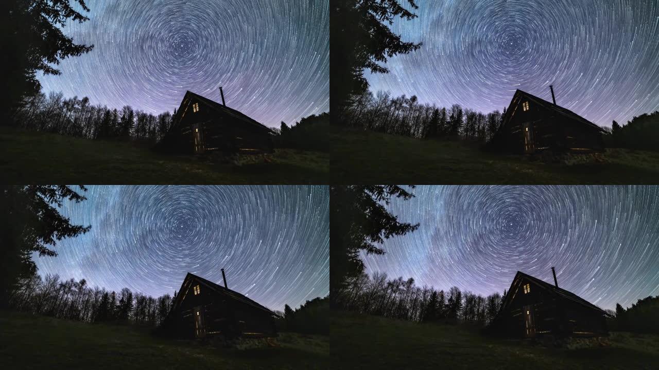 星际轨迹，银河系的恒星轨迹在夜空森林自然中古老的木屋上旋转