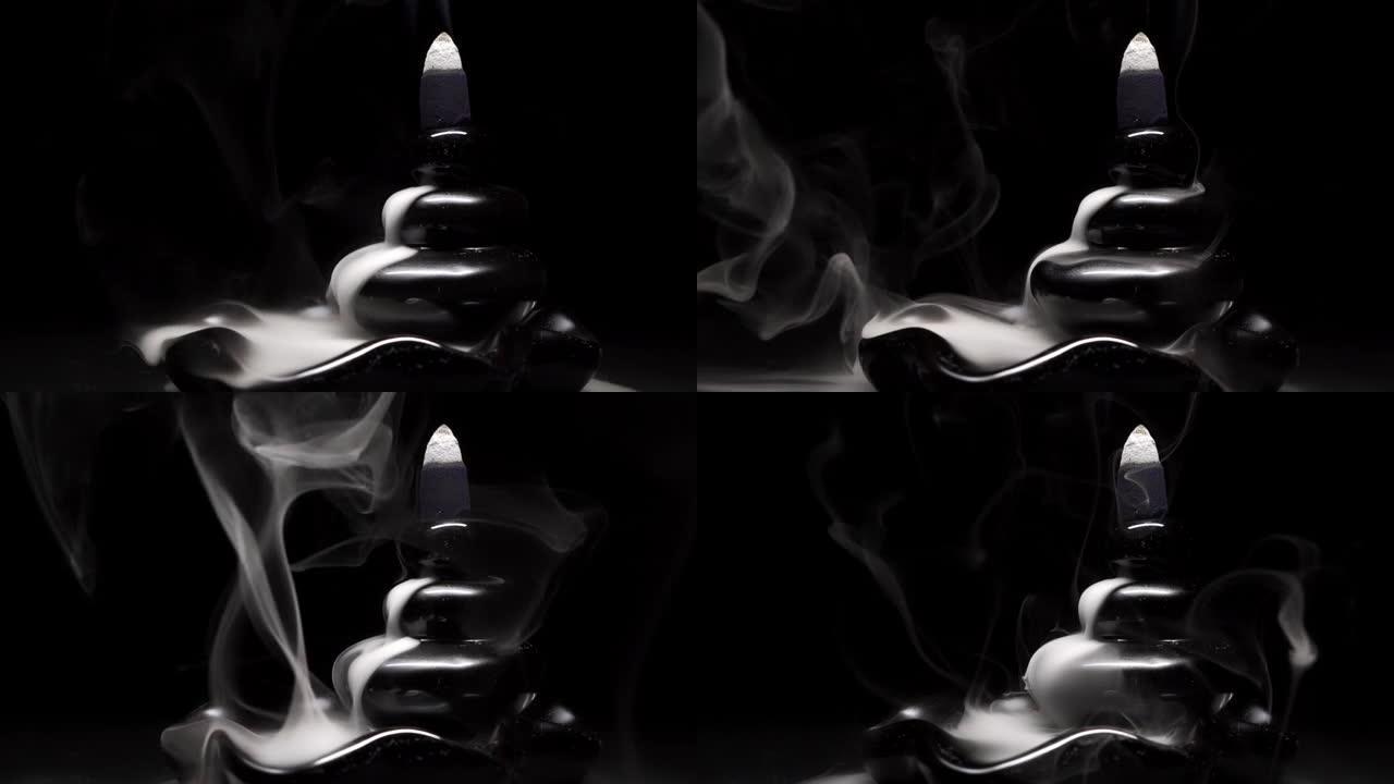 液体烟雾从阴燃的熏香锥中流出，用于冥想或瑜伽