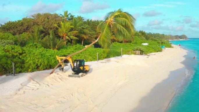 在一个热带岛屿上，黄色拖拉机的鸟瞰图将白色的沙滩上的棕榈树夷为平地。