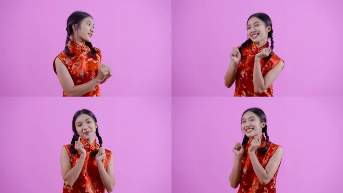 4K，扎着红色中国新年旗袍的中国血统的亚洲妇女，高兴地站着跳舞，竖起两个大拇指。微笑，开心，独自一人