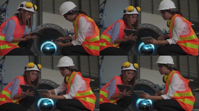 两名亚洲女性建筑工程师使用平板电脑，建筑概念在车间检查工作。