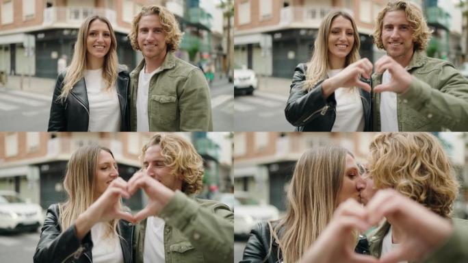 年轻的高加索夫妇微笑着自信地在街上用手做心脏符号