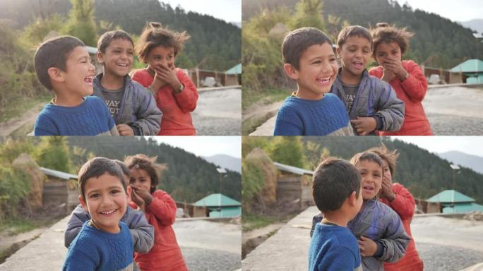 一群快乐可爱的年轻农村小孩看着相机大笑的户外特写