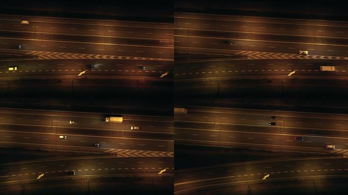 波兰华沙郊区的夜间高速公路的俯视图。无人机拍摄的照片显示了许多道路，桥梁，夜间有汽车通行的高架桥。