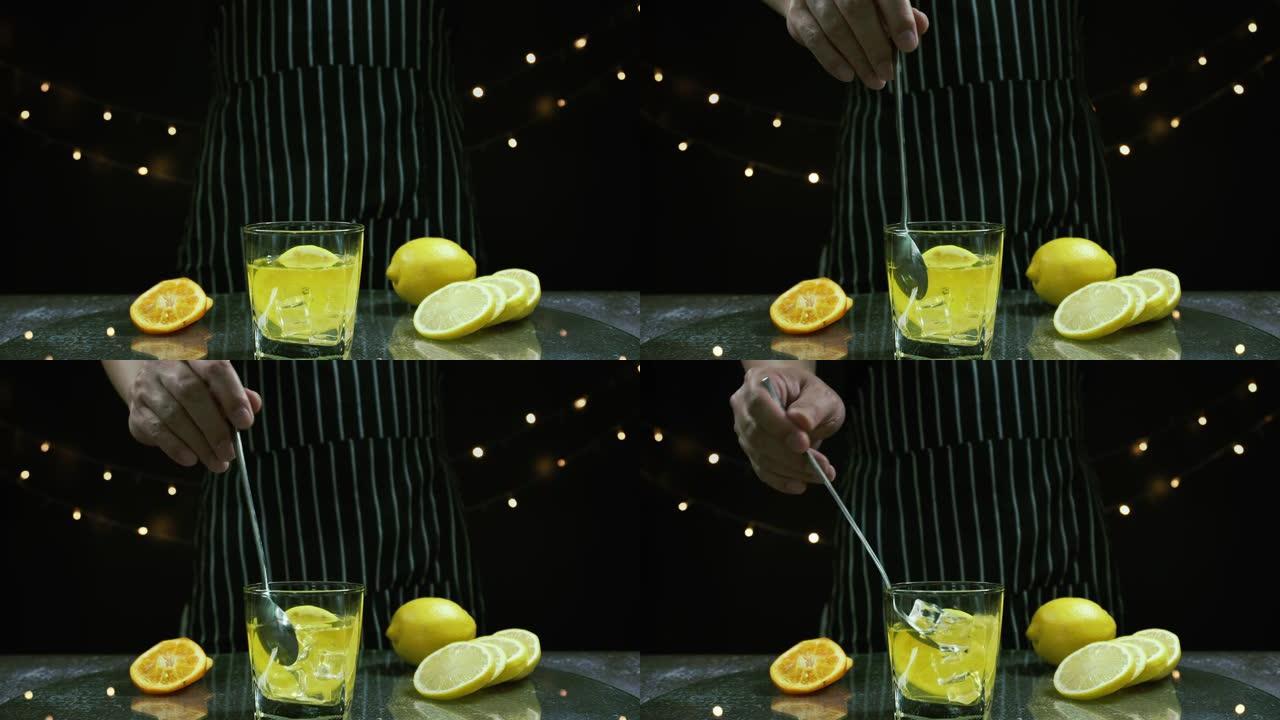 男子在桌子上搅拌冰块，将新鲜的柠檬和柠檬汁切成薄片