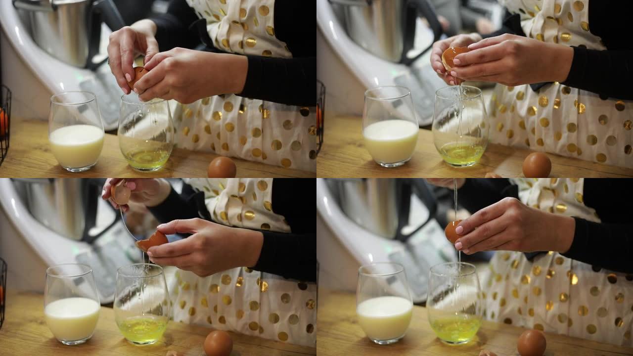 厨房里准备蛋糕的女人。把鸡蛋打碎成玻璃。烹饪。一杯牛奶。Ingirients。Homamade食物，