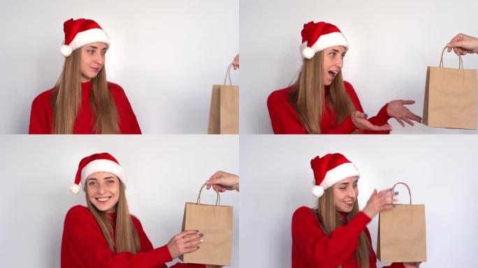 一个戴着圣诞老人帽子的年轻女子收到了一个装在工艺包里的礼物。