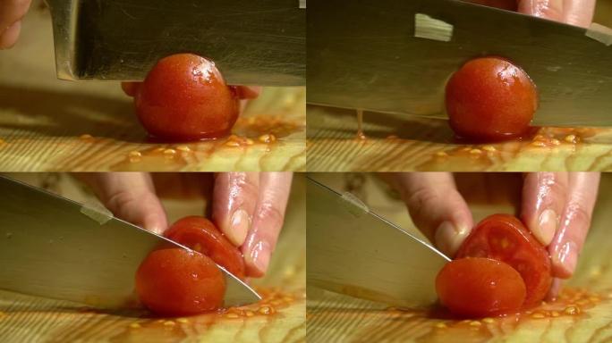 用刀将厨房中的樱桃番茄切成木板。特写。