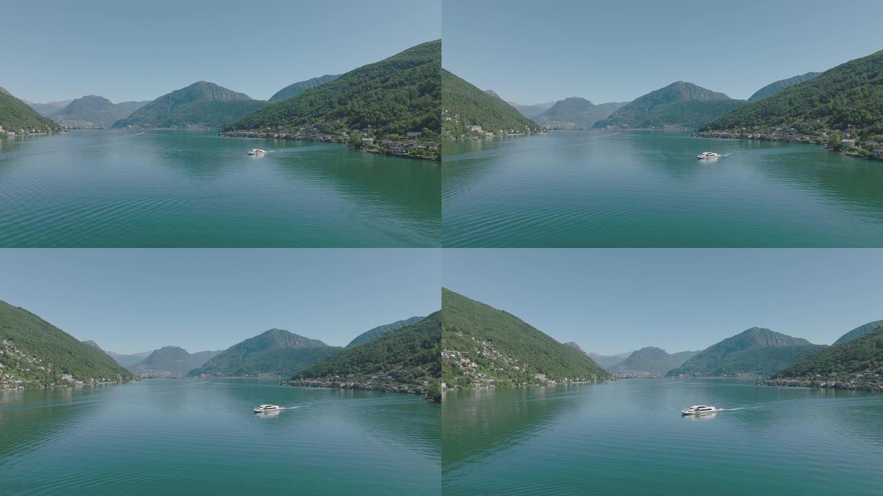 在湖上移动的渡轮的空中无人机视图