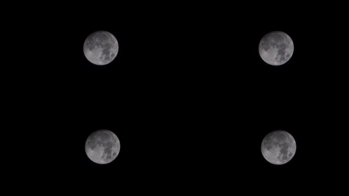 满月升起的月亮设定时间流逝，满月从左向右越过，在晴朗的天空中没有云，满月带有移动的乌云。夜间延时。没