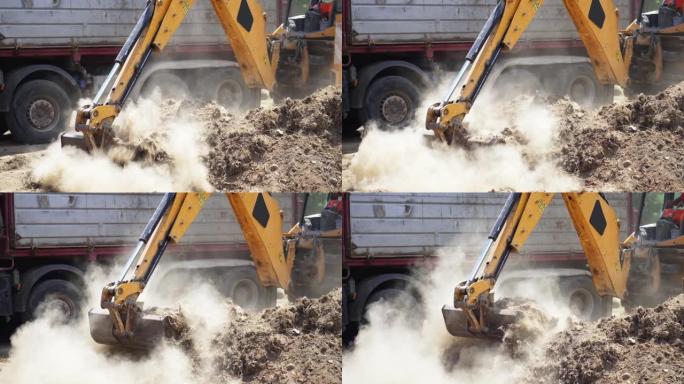工业挖掘机将高速公路施工现场的土壤材料装载到自卸车中，慢动作