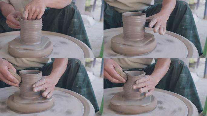 从陶艺轮上的陶艺团块上的女性陶艺塑形壶的镜头