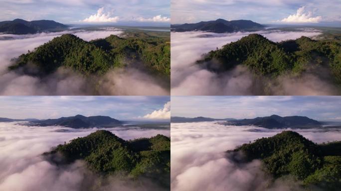 高角度视角无人机视图的雾在雨季越过山，美丽的日出天空云创造自然视频场景。4k高质量镜头