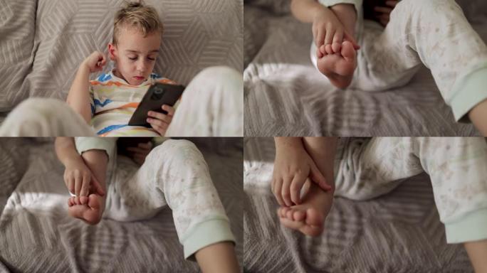 男孩在手机上玩电子游戏，一边抓挠皮肤，身上长满了痘
