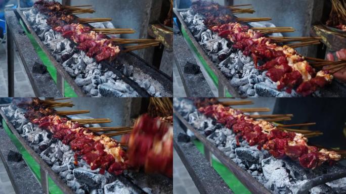 印度尼西亚中爪哇省萨拉蒂加的带竹扇的山羊沙爹烧烤。