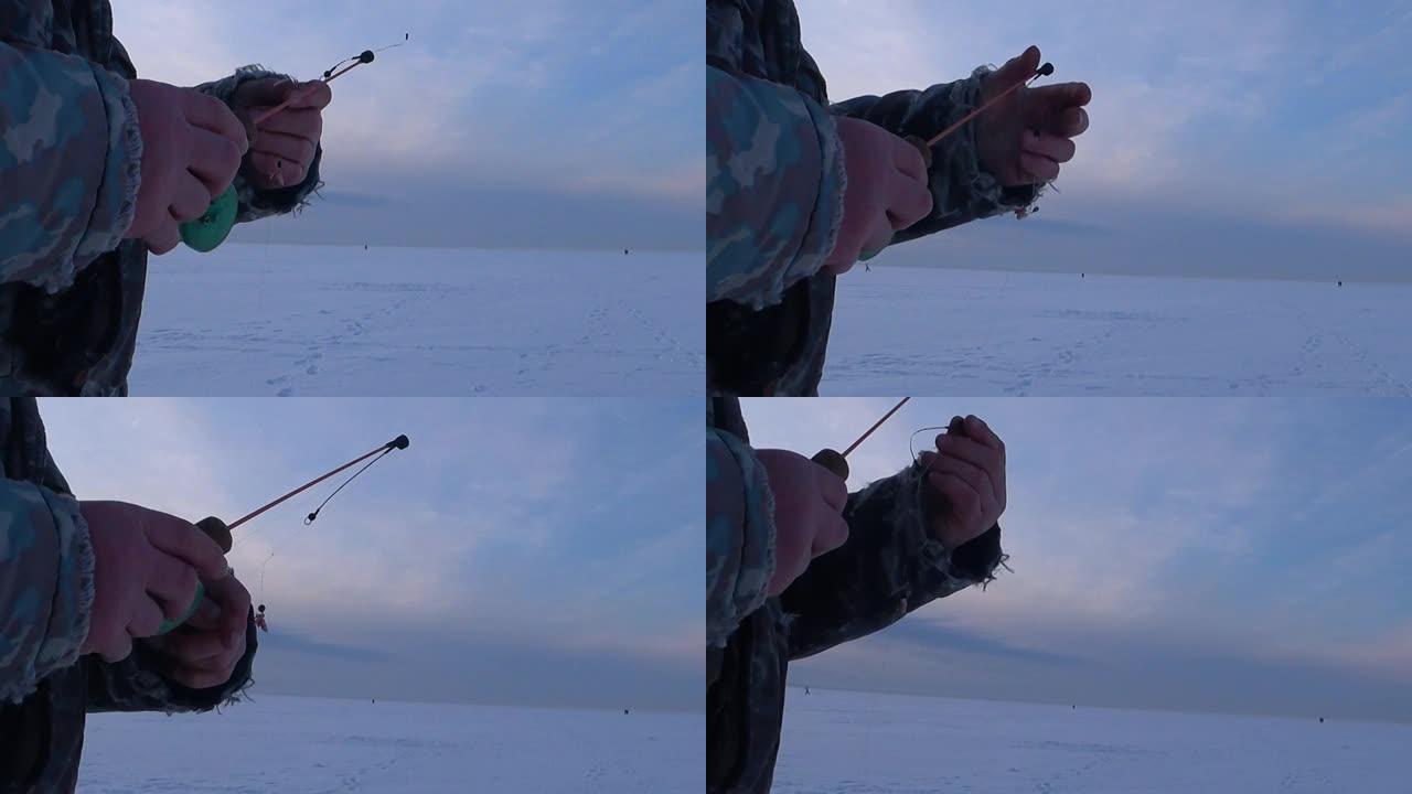 一个男人，一个渔夫，用冰钓鱼竿钓鱼