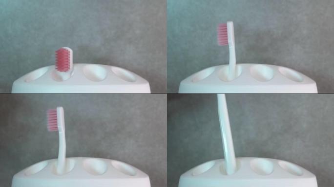 一个男人从一个白色的箱子里拿了一把白色的牙刷。牙科保健。健康牙齿概念。在浴室刷牙
