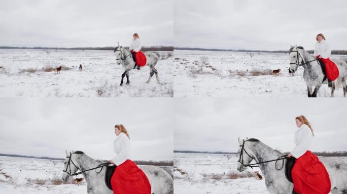 穿着红色连衣裙的女人在冬天的田野里骑着小跑