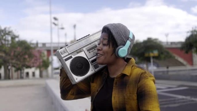 年轻的非洲裔美国妇女在户外演唱城市音乐，背景是城市