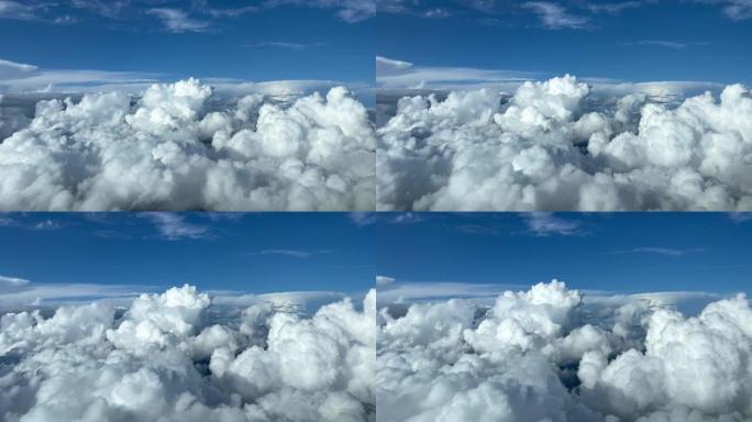 喷气式飞机驾驶舱飞越暴风雨的积雨云和深蓝色的天空，令人敬畏。试点观点。4K 60 FPS。