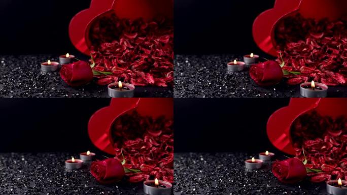 情人节: 红玫瑰、蜡烛、心形礼盒和黑色背景