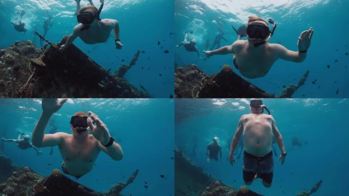 男子在马尔代夫清澈的水中在沉船上游泳和浮潜