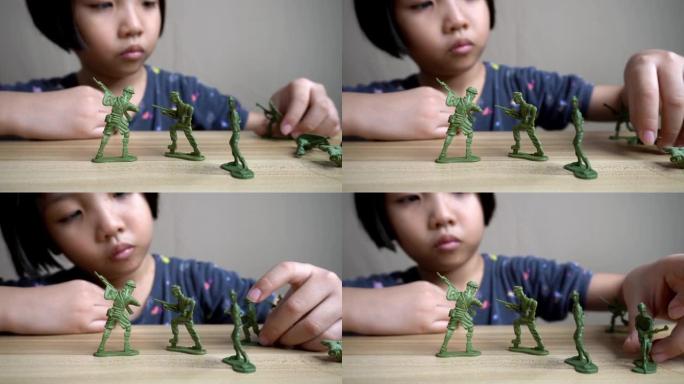 小女孩玩绿色的士兵玩具