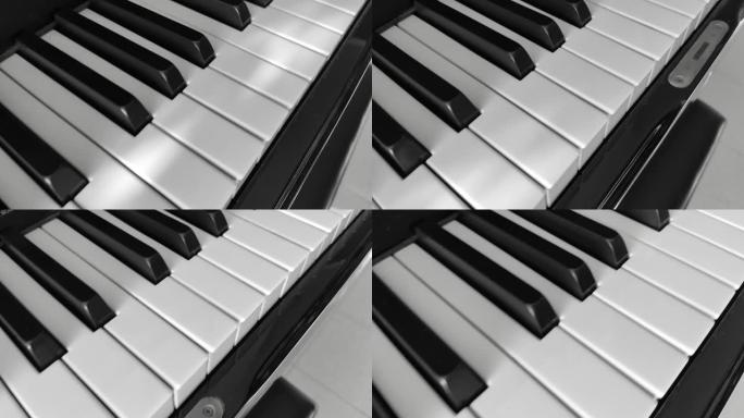 相机以黑白效果在钢琴键盘上滚动