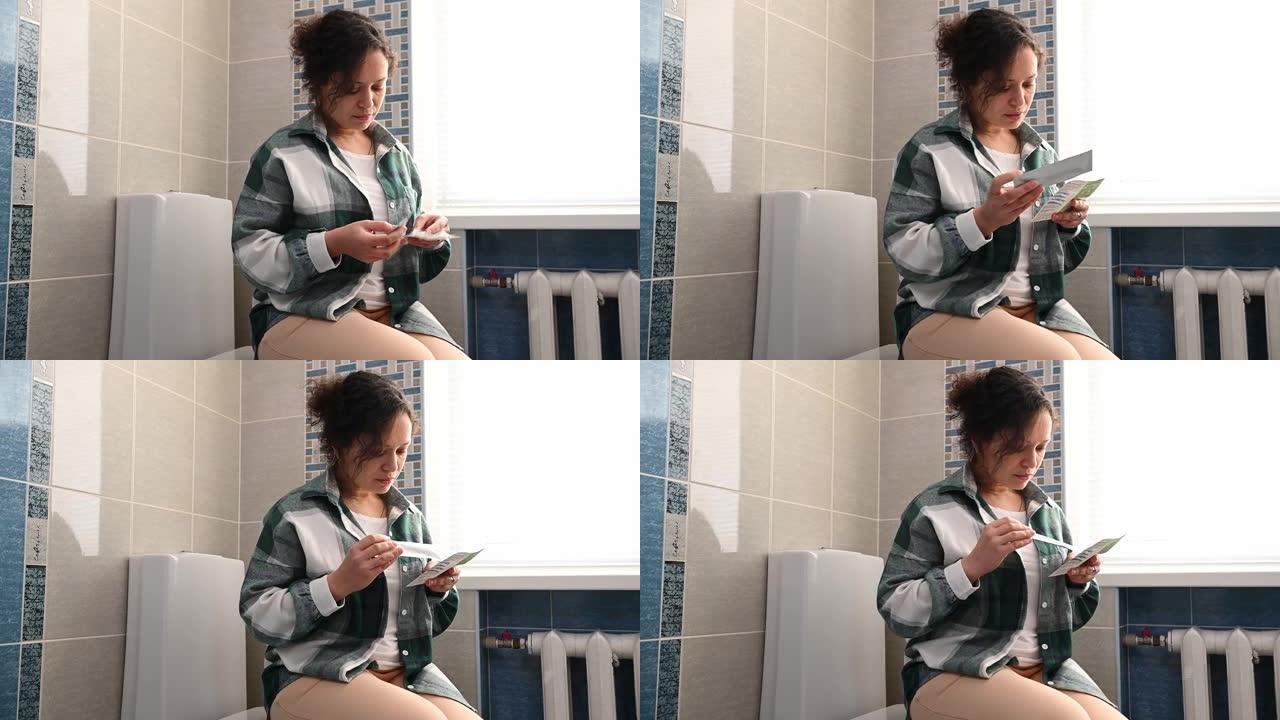 一名中年妇女坐在浴室里，阅读使用妊娠试验的说明