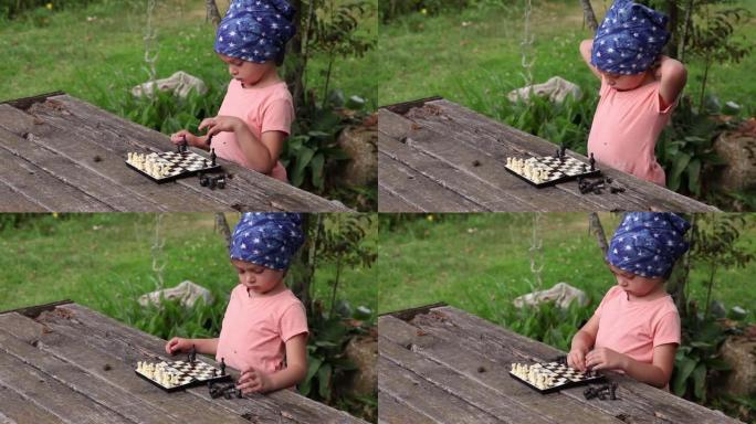 紧张的小女孩在后院的棋盘上设置棋子