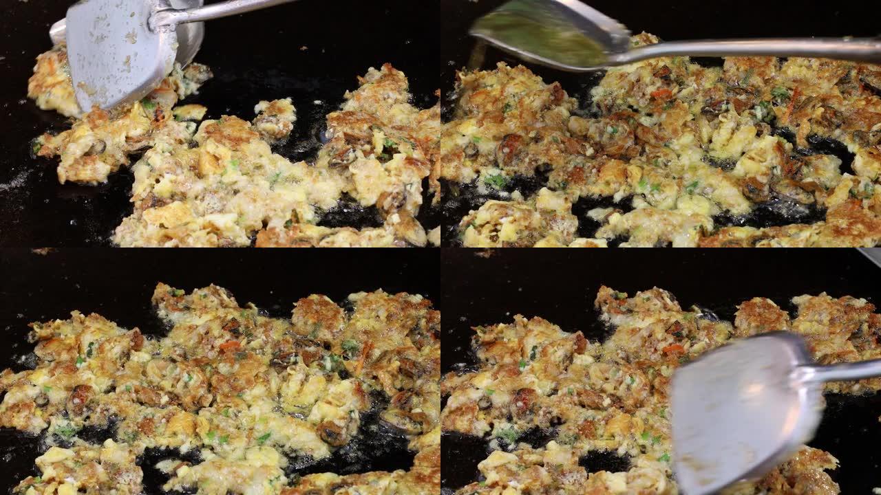 在锅中煮熟的鸡蛋炒贻贝的特写镜头。