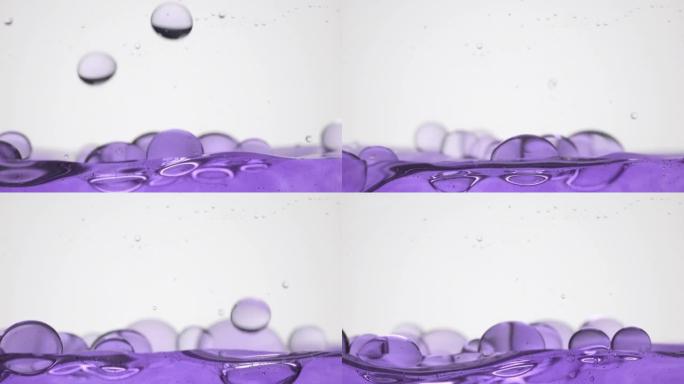 紫色气泡下降到紫色表面弹跳和破裂