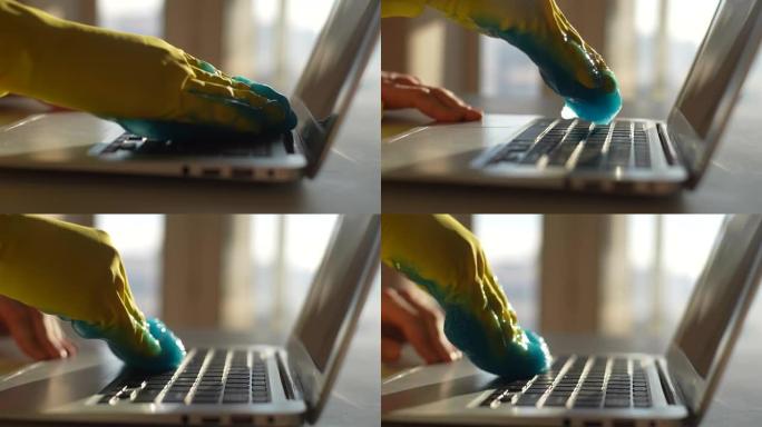 戴着防护手套的无法识别的男子的特写侧视图使用蓝色粘液吸收凝胶清洁和清除笔记本电脑键盘上的灰尘。