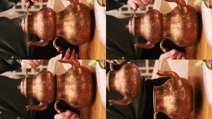女孩用手举起两个土耳其国家茶壶。茶道。特写。垂直视频