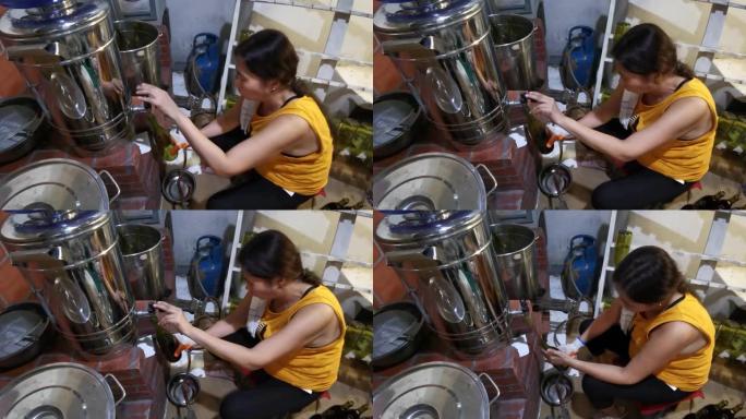 亚洲妇女手动装瓶果酒，男人在当地一家小型酿酒厂工作时盖上瓶盖