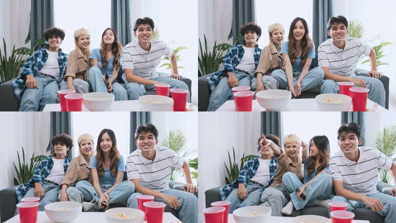 一群快乐的亚洲年轻人在家里一起看电视，吃爆米花零食，笑着一起笑。有趣的周末休闲活动，亲密的朋友关系或